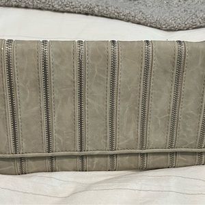 Light grey vegan leather clutch with silver zipper detail.